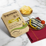 Packaging and a glass dish displaying boquerones (Spanish white anchovies) marinated in vinegar and preserved in organic extra virgin olive oil.