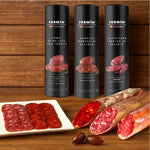 Three Fermin sausages packages with sliced sausages on a wooden background