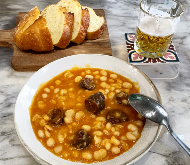 white beans with chorizo on a plate with bread