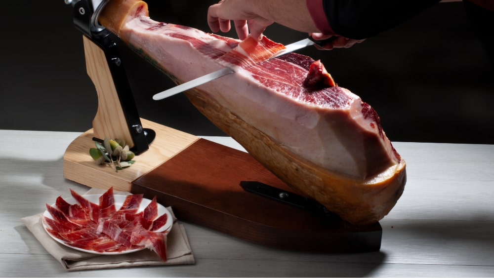 jamon iberico on a ham stand with a knife