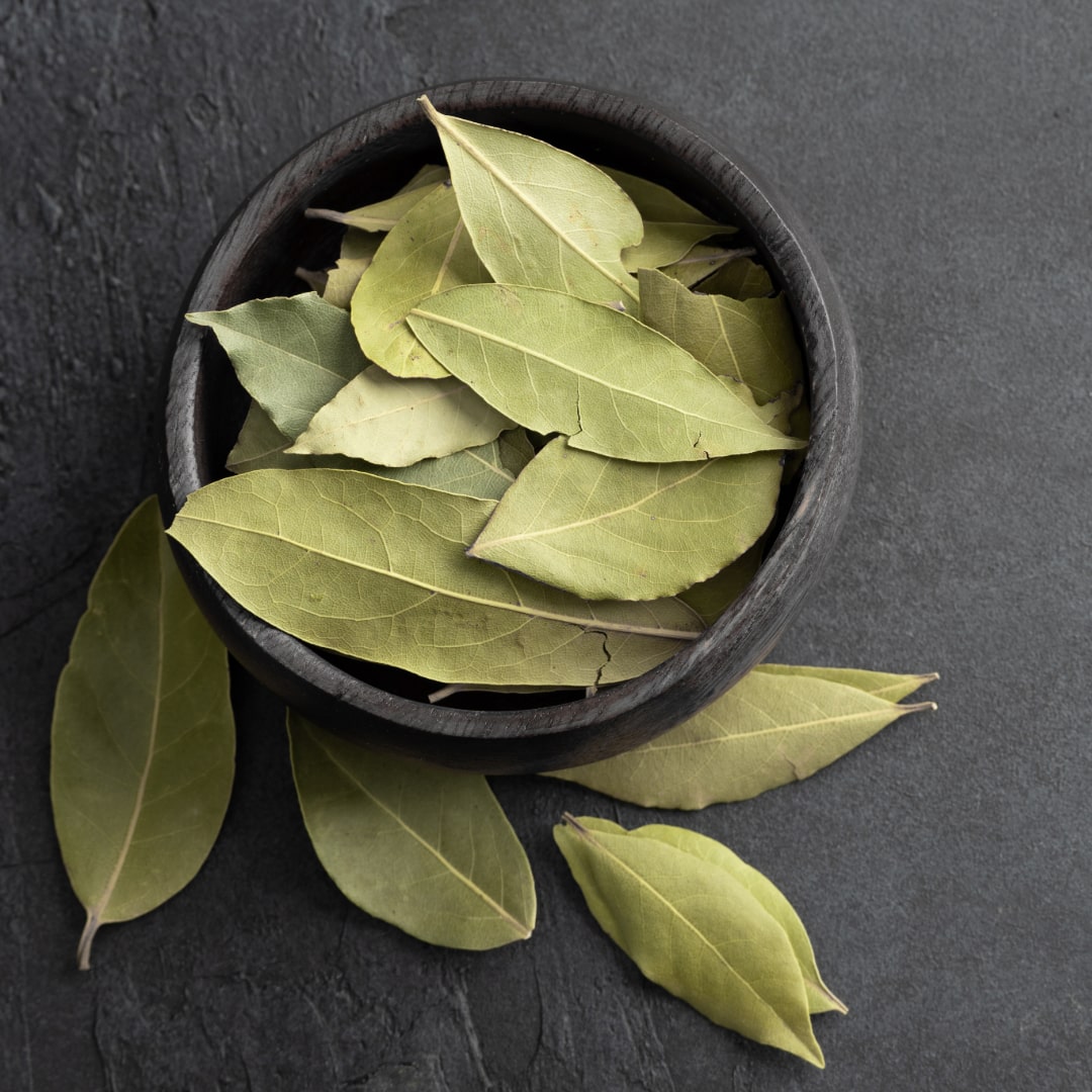 Whole bay leaves on a bowl