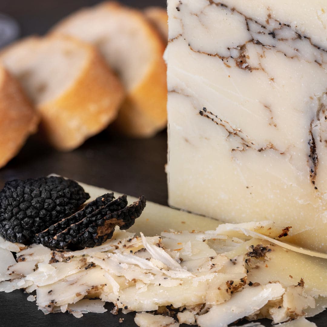 Piece of cheese with black truffles 