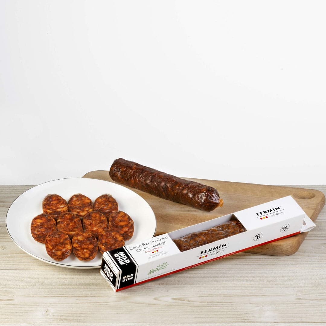sliced chorizo on a plate on a wooden board
