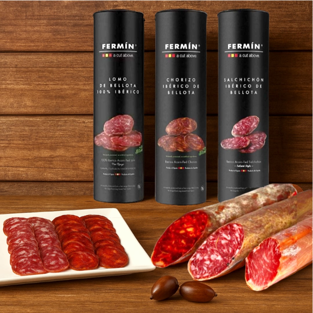 Three Fermin sausages packages with sliced sausages on a wooden background