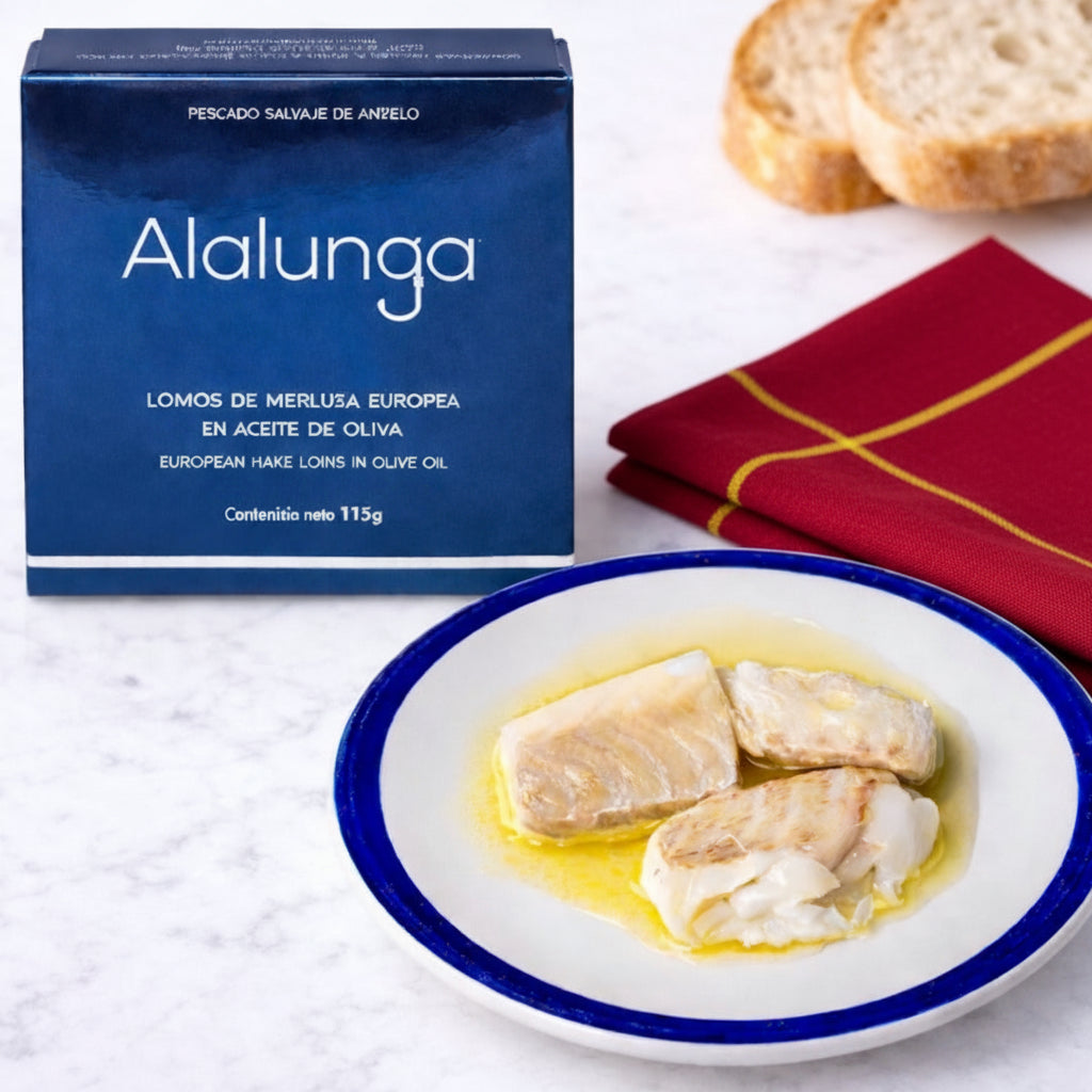 Alalunga packaging with a plate of hake loins on a marble surface