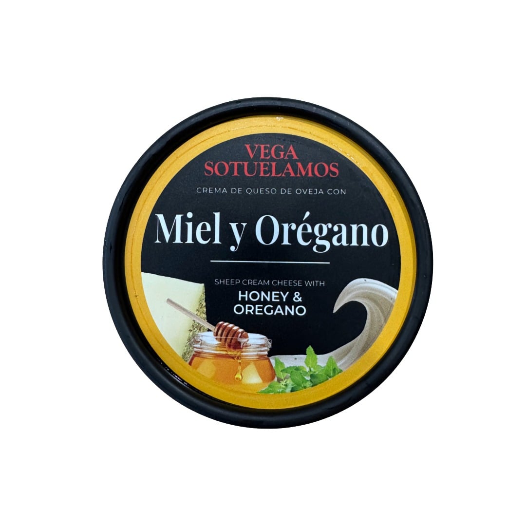Container of sheep cream cheese with honey and oregano on a white background