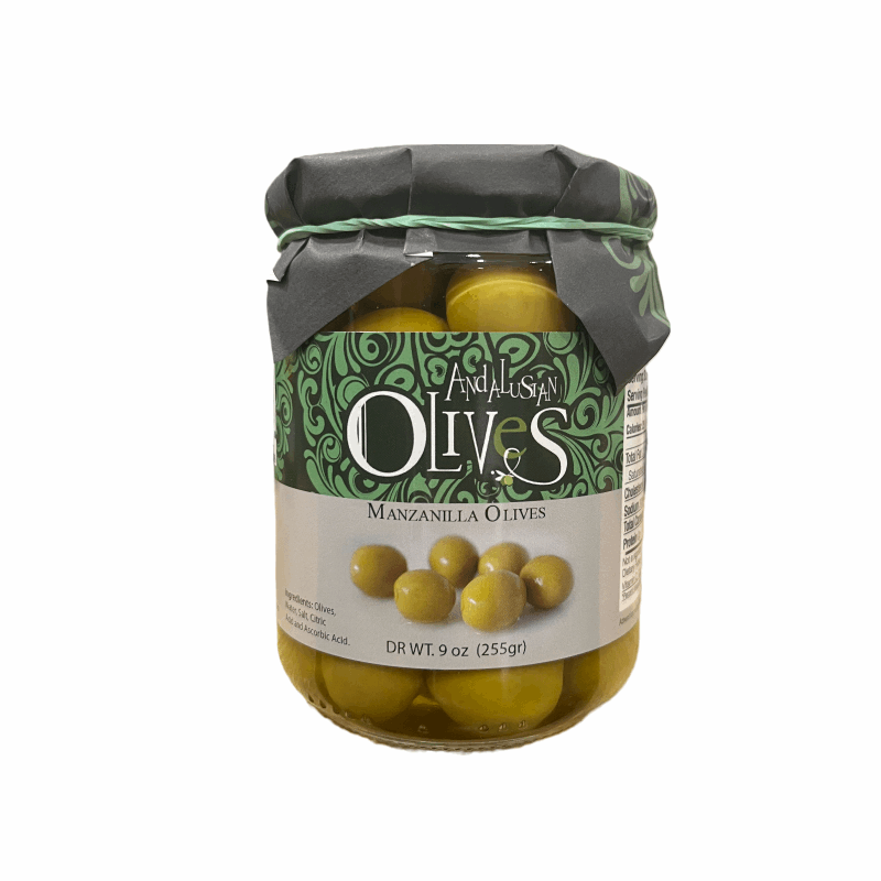 a glass jar with a label green and grey and a green paper on the top with olives inside