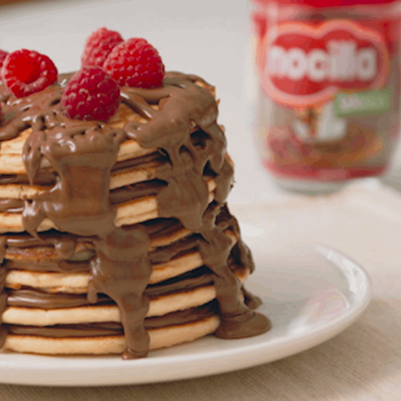 pancakes with melted chocolate and strawberries on top
