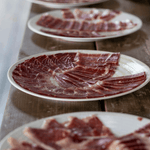 three plate with Iberian ham on top