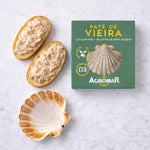 Scallops pate on bread with a green Agromar packaging on a white marble surface