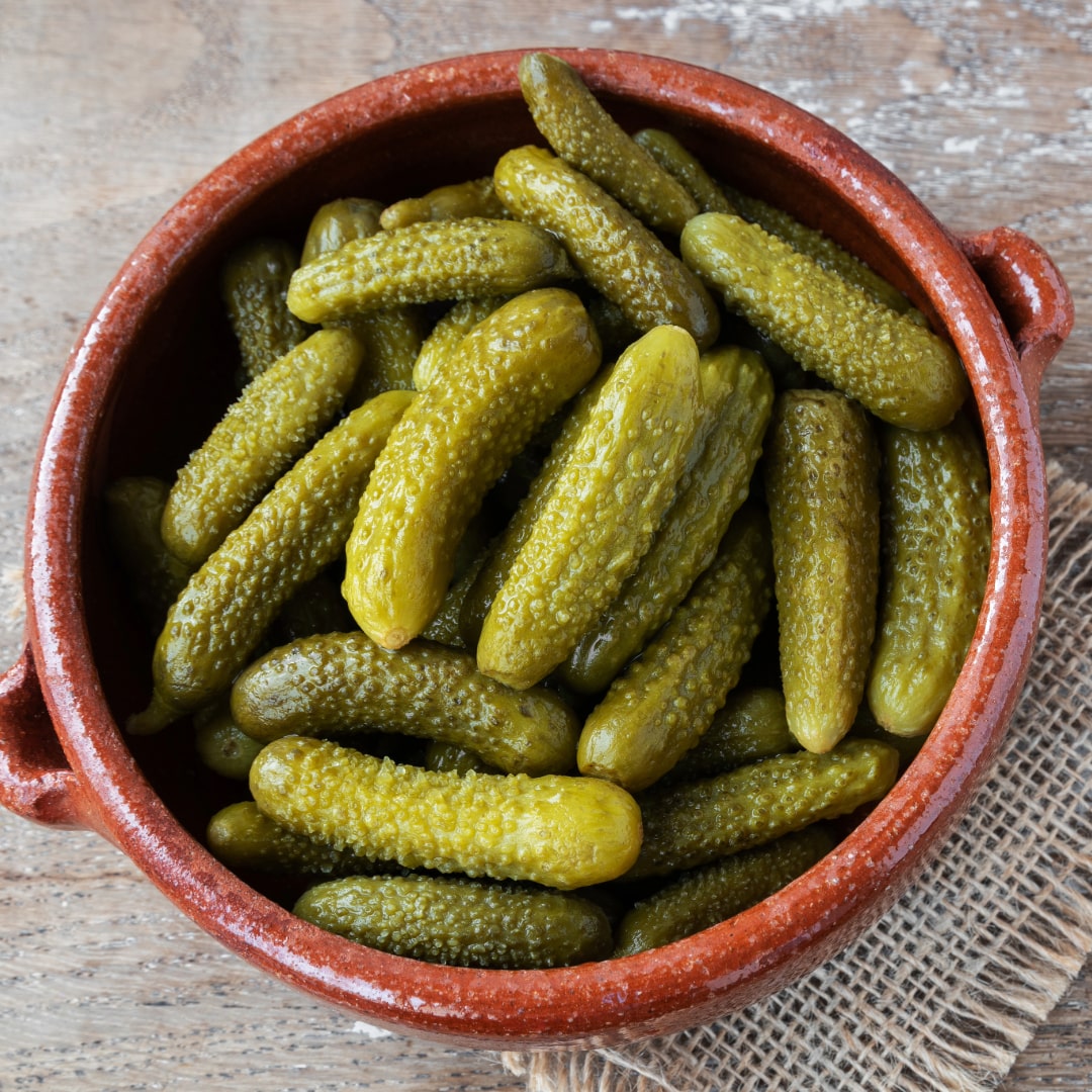 pickled gherkins on a terracotta casserole