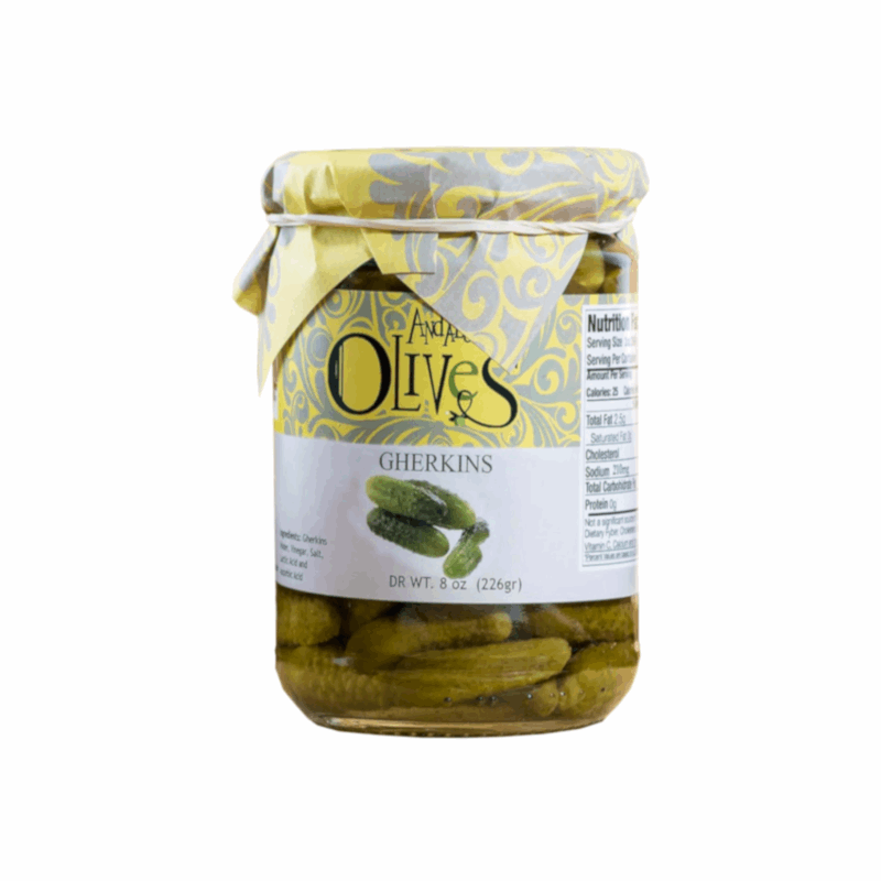 a glass jar with a label yellow and grey with gherkins inside