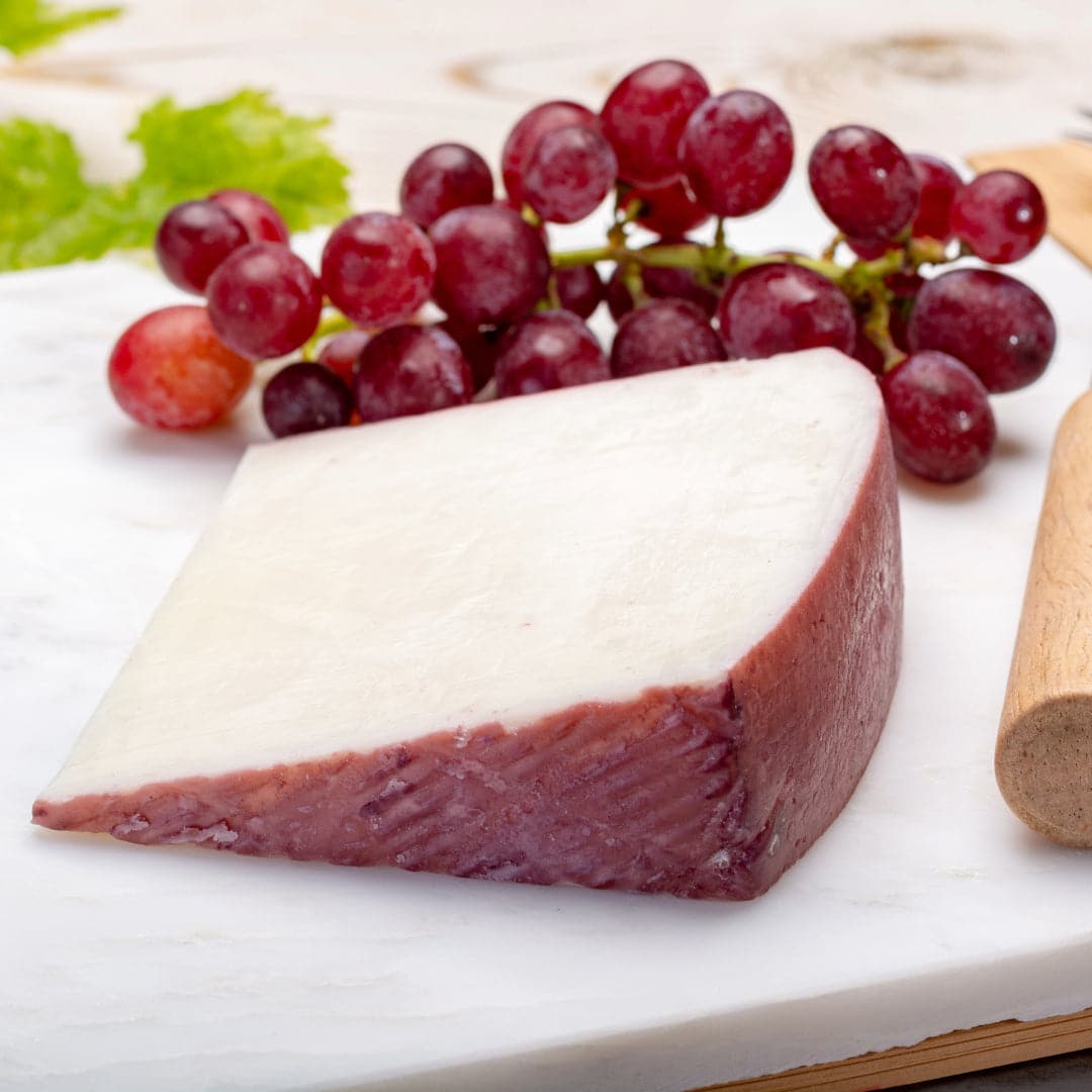 Wedge of cheese with grapes