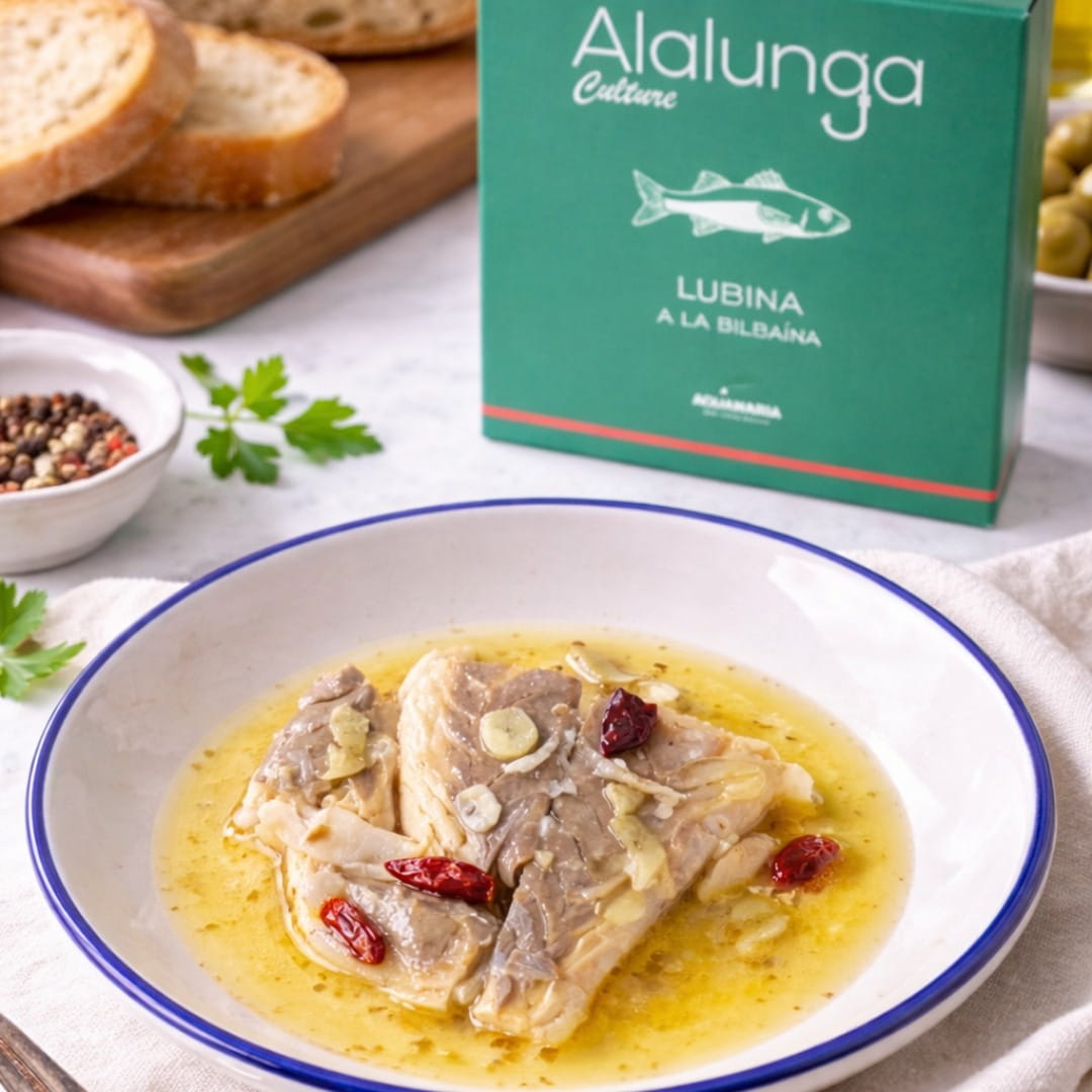 Dish of fish in a broth with 'Alalunga' packaging in the background