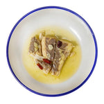 seabass in a plate with a blue rim on a white background