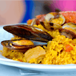 a plate with seafood paella with mussels