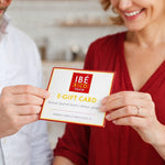 Two people holding an IbeRico Taste e-gift card in a kitchen setting