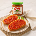 Hida grated tomato spread on bread with a jar of Hida grated tomato spread in the background.