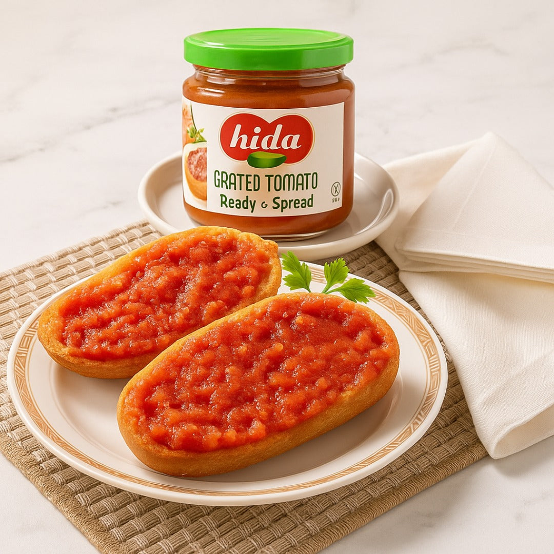 Hida grated tomato spread on bread with a jar of Hida grated tomato spread in the background.