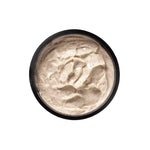 Black bowl filled with a creamy beige substance on a white background